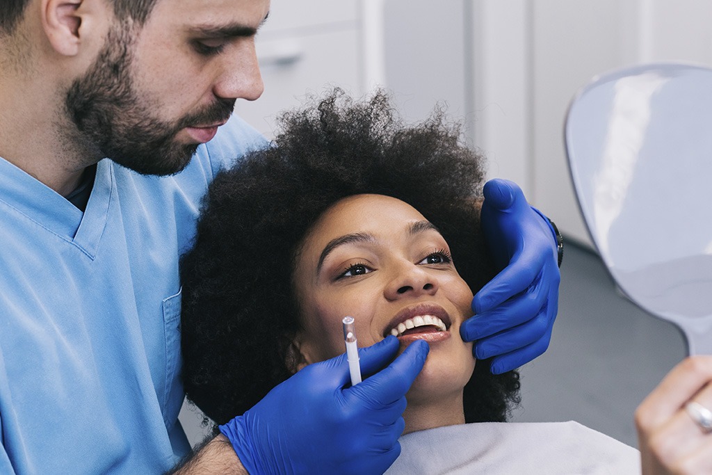 Dental Veneers Close-up of a woman receiving dental treatment with a dentist in a modern clinic