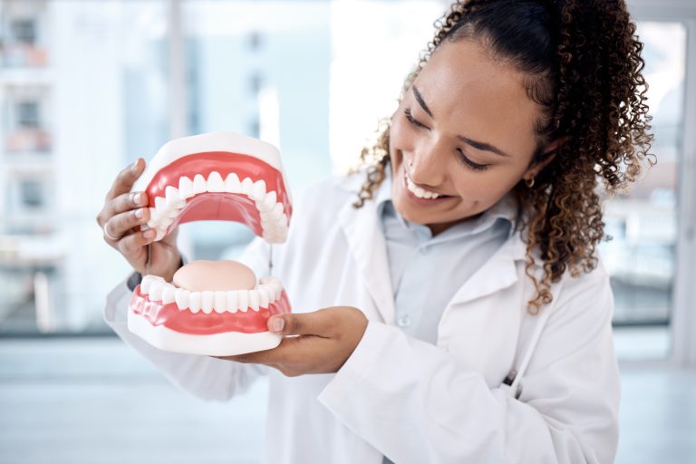 Professional dentist performing an oral hygiene procedure on a patient in a modern, well-lit dental office.